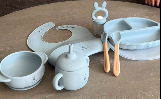 Load video: Toddler enjoying mealtime with a 7-piece silicone baby feeding set designed for self-feeding, snacks, and starting solids.